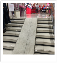 Photograph of a steep ramp at the entrance of a department store.
