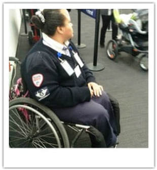 Photograph of a female airport employee who uses a wheelchair